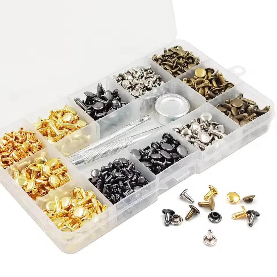 A clear plastic box filled with various precision metal rivets and fasteners for leather and fabric repair