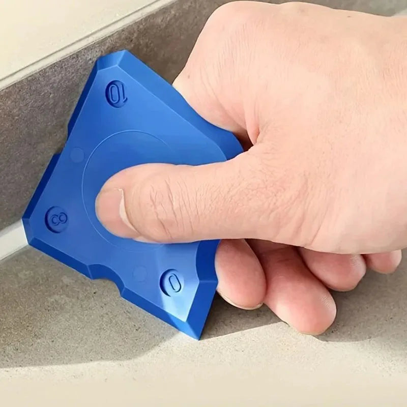 A hand is holding a blue silicone caulking tool set with four distinct sealing shapes.