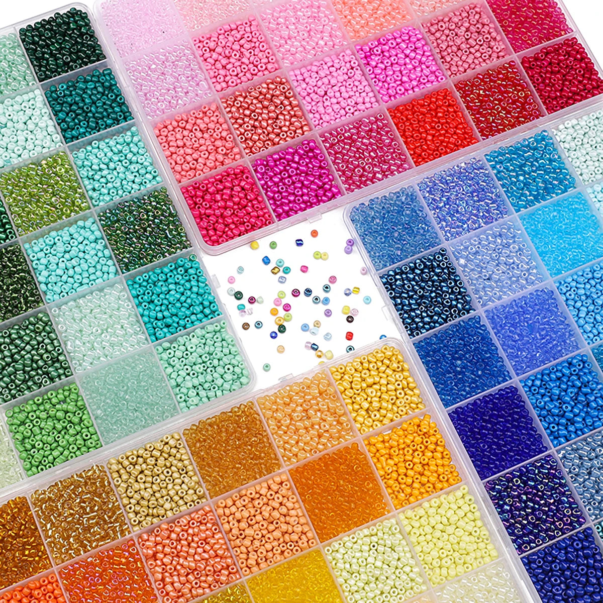 A variety of colorful acrylic rice beads in various shades and sizes arranged in a clear plastic tray.