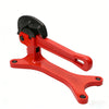 Red portable pipe vise with a black jaw used for valve maintenance.