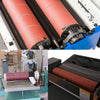 Close-up view of aluminum oxide sandpaper rolls being used in a machine for sanding wood and metal.