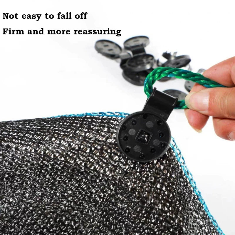 Close-up of heavy-duty black clips used to secure netting or fabric, demonstrating a firm grip.