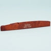 A wooden guitar bone bridge saddle labeled Guyker ATR-7439