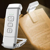 A white rechargeable book light is shown resting on an open book page.