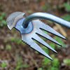 A close-up of a stainless steel hand tool with a curved handle and multiple sharp tines for deep root weed removal.