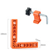 Orange L-shaped angle positioner tool with a black clamp and silver rod for woodworking