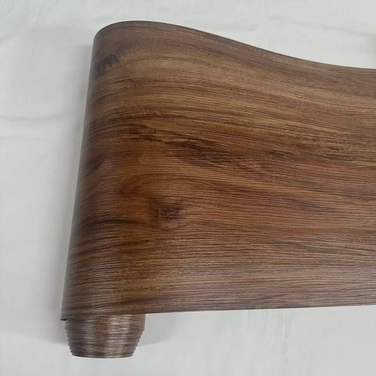 A close-up view of a thick, dark brown wood grain self-adhesive wall decal.