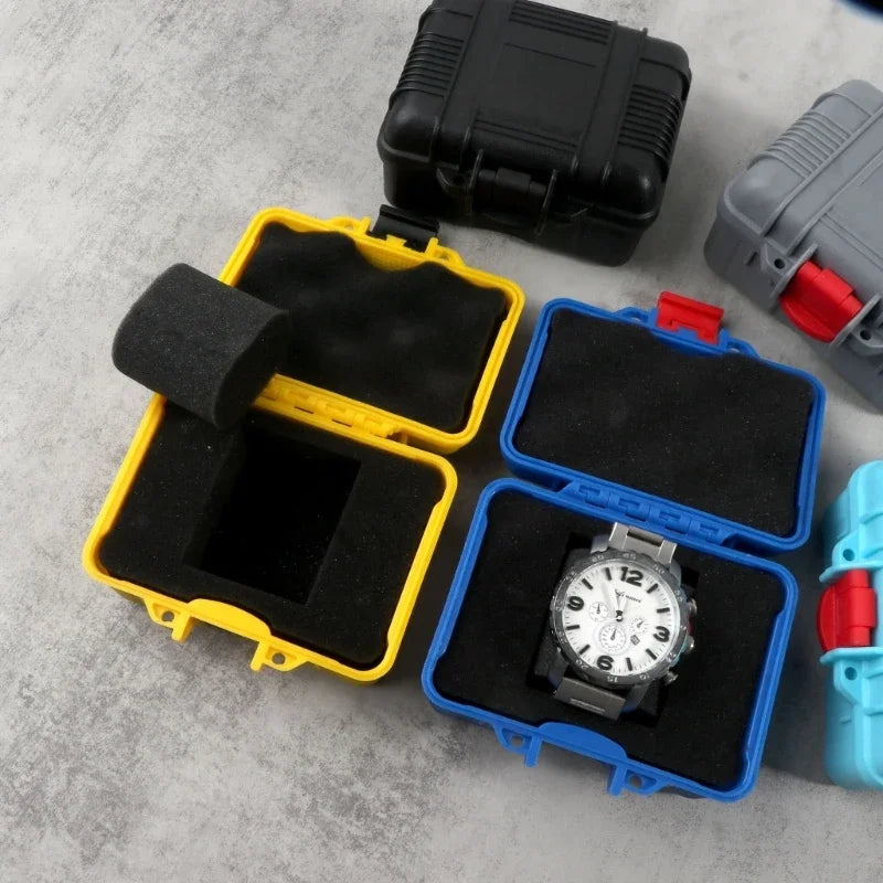 A collection of impact-resistant watch storage cases in black, yellow, and blue plastic and foam.