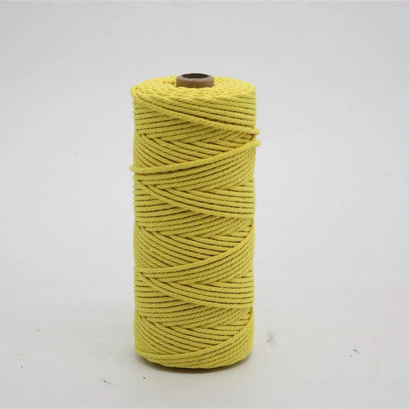A spool of 100m natural cotton macrame cord in a bright yellow color.