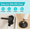 A close-up of a black adjustable portable door security bar mounted on a white door frame.