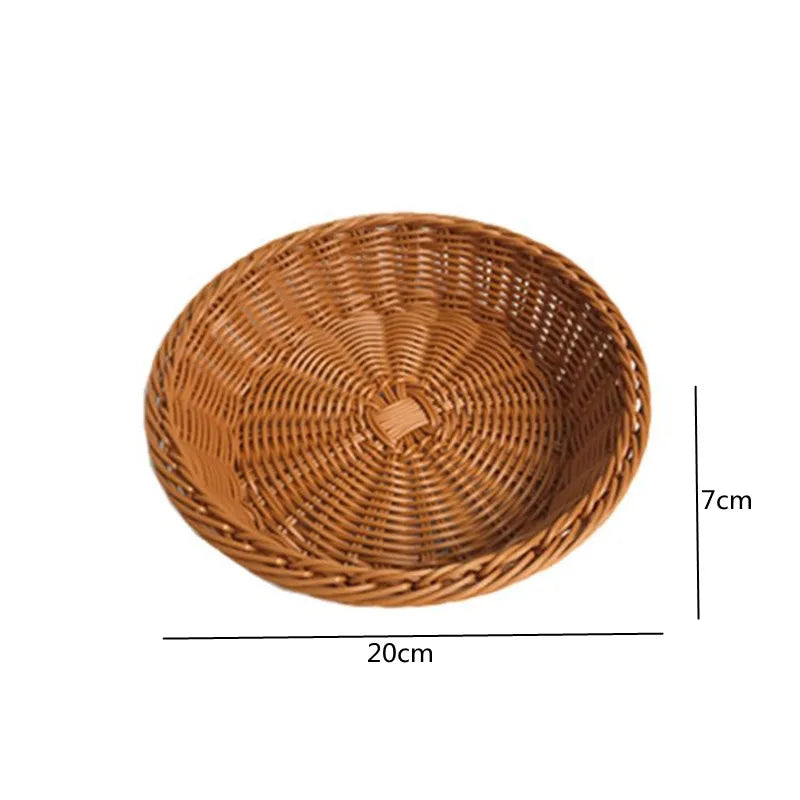 A round, shallow serving basket made of natural brown rattan woven material.