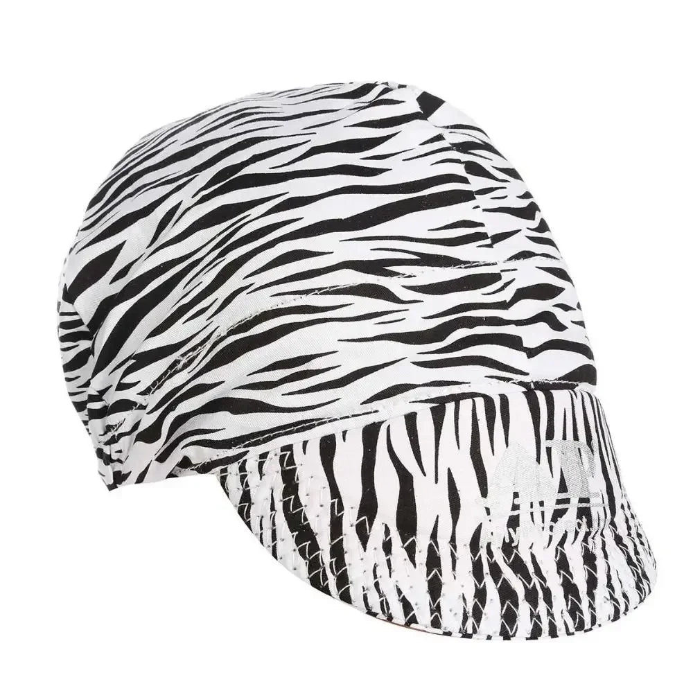 A close-up view of a durable welding and work cap with a black and white zebra stripe pattern.