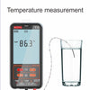 A digital multimeter displays a temperature reading of 86.3 degrees Celsius next to a glass of water.