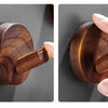 A close-up of a rustic wooden wall hook with a natural finish, shown in two views.