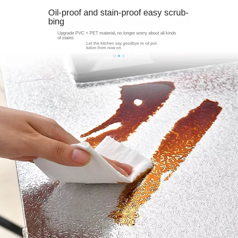 Eine Hand wischt eine Fleck ab von einem Aluminiumfolien-Aufkleber zur Küchendekoration.