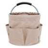 A beige large folding storage organizer basket with a black handle.