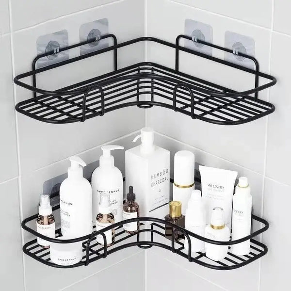 Black wall-mounted metal bathroom organizer shelves holding various white and brown liquid products