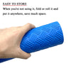 A hand is holding a bright blue non-slip pool ladder mat, demonstrating how to fold or roll it to save space.