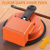 An orange floor gaps fixer tool with a suction cup mechanism shown on a wooden surface.