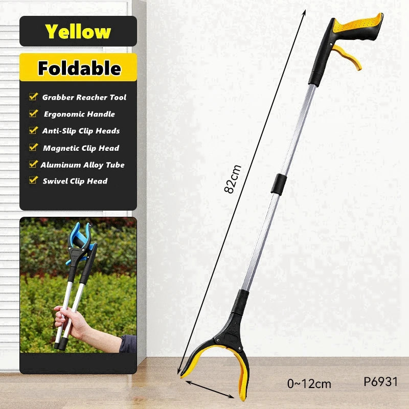 A yellow foldable silicone garbage grabber tool with a black handle and silver tube is shown against a white background.