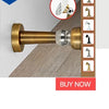 A close-up view of a brass portable keyless door lock mechanism with a silver cylinder and a screwdriver tool.