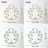 A set of large and small plant support frames made of natural wood-colored material for Monstera plants.