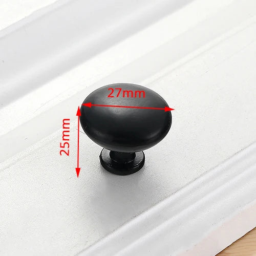 A black stainless steel kitchen door pull handle with a 27mm diameter and 25mm height shown against a white surface.