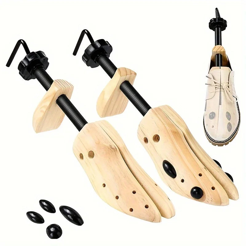 A set of wooden shoe stretchers with black handles and light wood soles.
