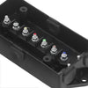 A black distribution block with seven threaded posts for waterproof power connectors.