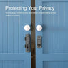 Close-up of a blue wooden door with a stainless steel barn door lock and two round security buttons.