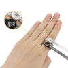 A hand wearing a precision ring sizer and magnifier tool for measuring rings.