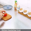 Kitchen countertop cover showing various kitchen items including a foil bottle, jar, and round white containers.