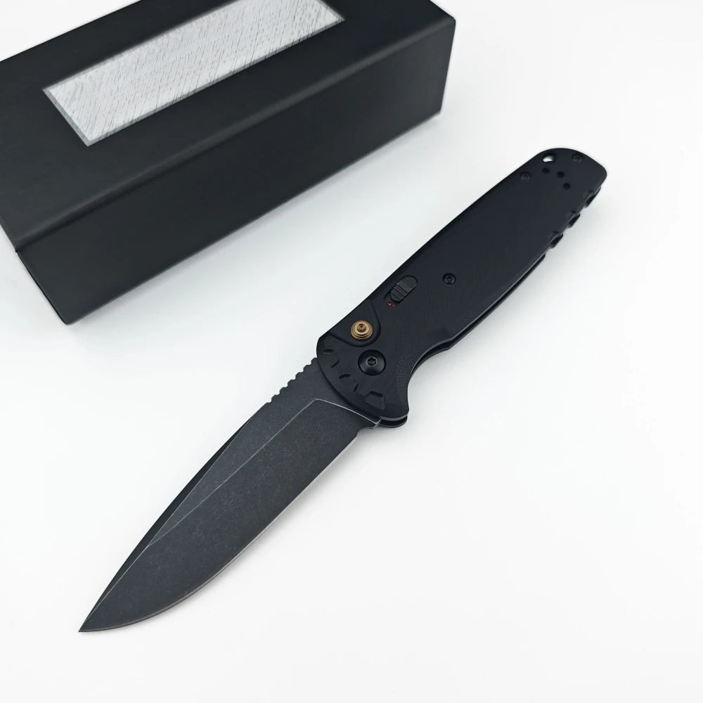 A black folding utility knife with a black handle and blade is shown next to its sheath.