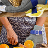 A hand wearing a stainless steel anti-cut safety glove is holding a seashell, demonstrating the product's use.