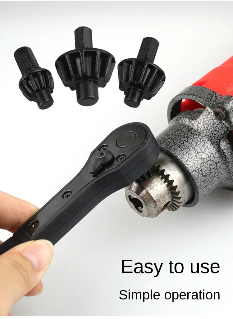 A black electric drill and ratchet key set with various bits shown next to a red tool.