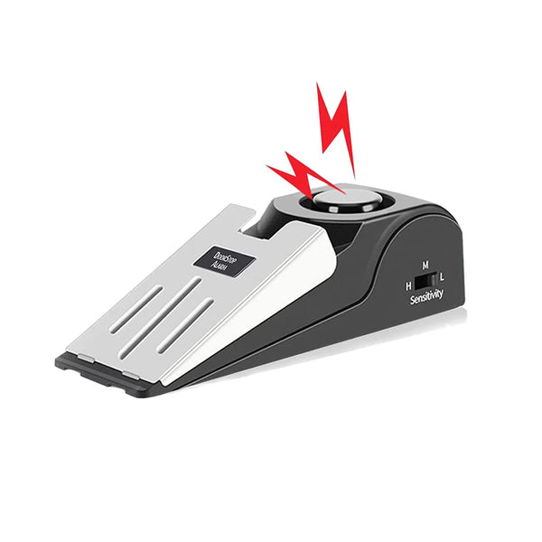 A black portable door stopper alarm wedge with a silver plate and a red lightning bolt symbol.