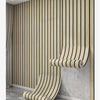 A close-up of thick wood grain self-adhesive wall decals installed vertically on a light gray textured wall.