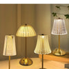 Three modern gold-toned lamps with translucent shades illuminate a room.