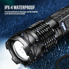 A black tactical flashlight with a bright white beam is shown against a dark, wet background.
