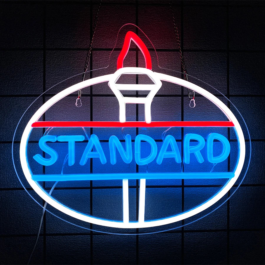 A glowing blue and red neon sign shaped like a globe with the word STANDARD displayed on it.