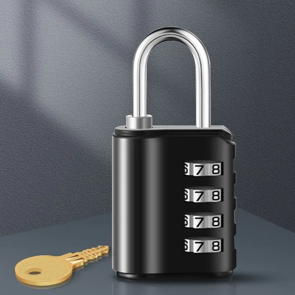 A black heavy duty combination lock with a silver shackle and a yellow key lying next to it.