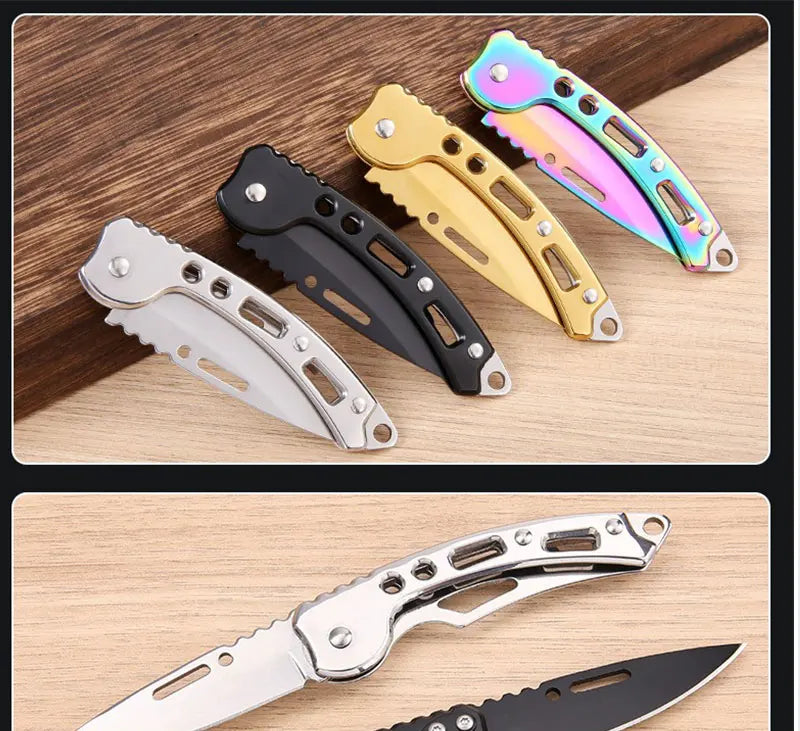 A collection of stainless steel folding keychain knives in various colors and finishes displayed on a wooden surface.