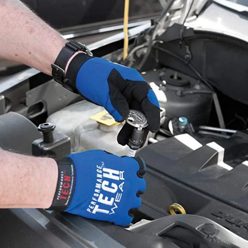 A hand wearing a blue Performance Tech tool is using a precision spark plug gap gauge on an engine component.