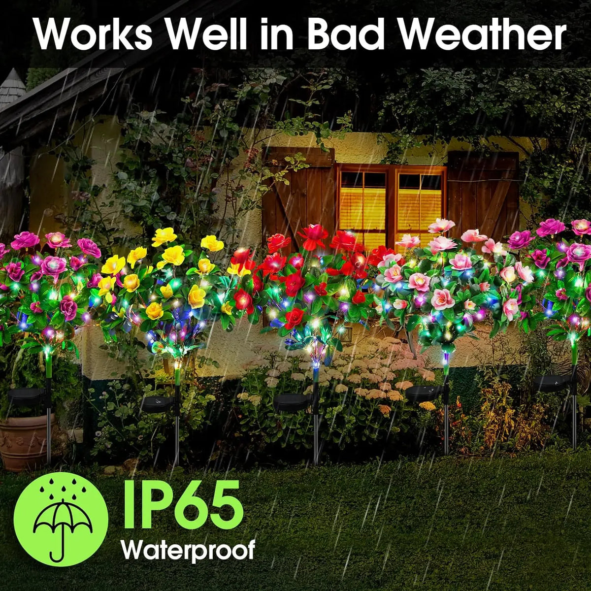 Solar LED azalea flowers in various colors line a garden wall during a rain shower.