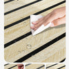 A hand wipes water off a wood grain surface with a white cloth, demonstrating the easy to clean and waterproof nature of the 