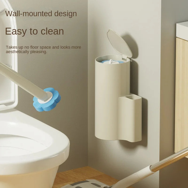 A wall-mounted toilet brush set with a white handle and blue bristles is shown next to a toilet.