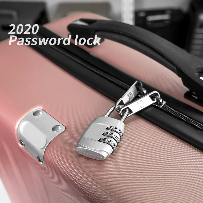 A silver dial password lock is attached to a pink suitcase zipper, demonstrating a 2020 password lock.