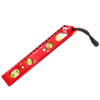 A red magnetic level ruler with multiple measurement markings and a black strap.