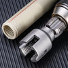 Close-up of an electric drill pipe thread cutting tool with a white and silver tube visible on a dark surface.