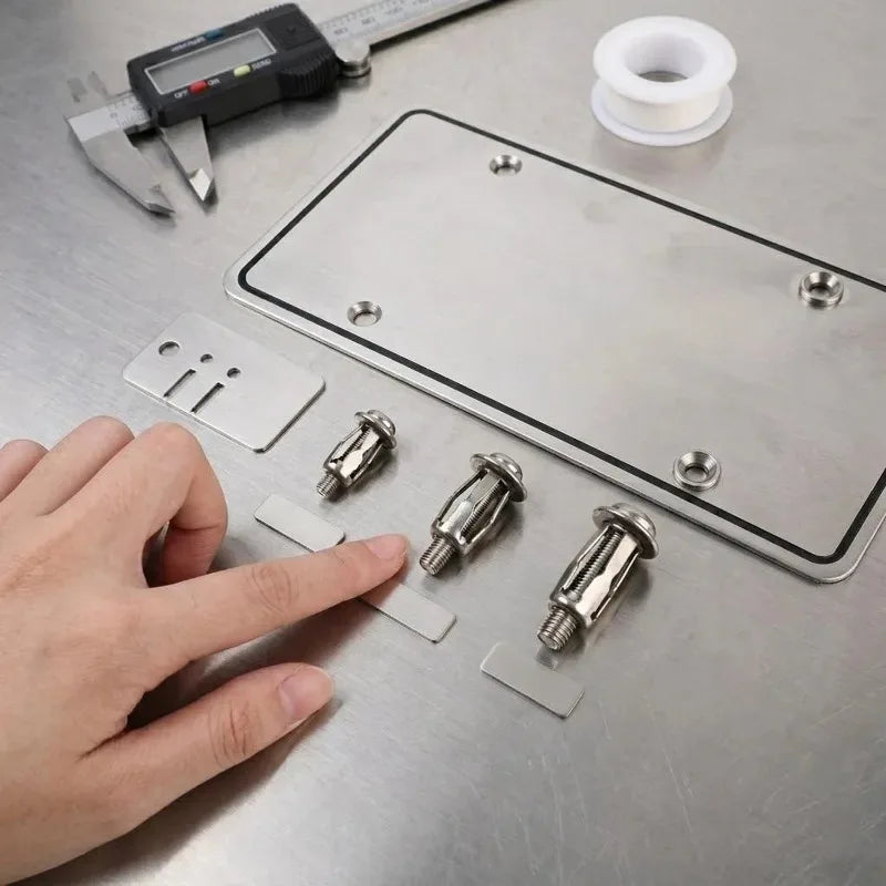 A hand places stainless steel expansion rivet nuts onto a metal plate for license plates next to a measuring tool.